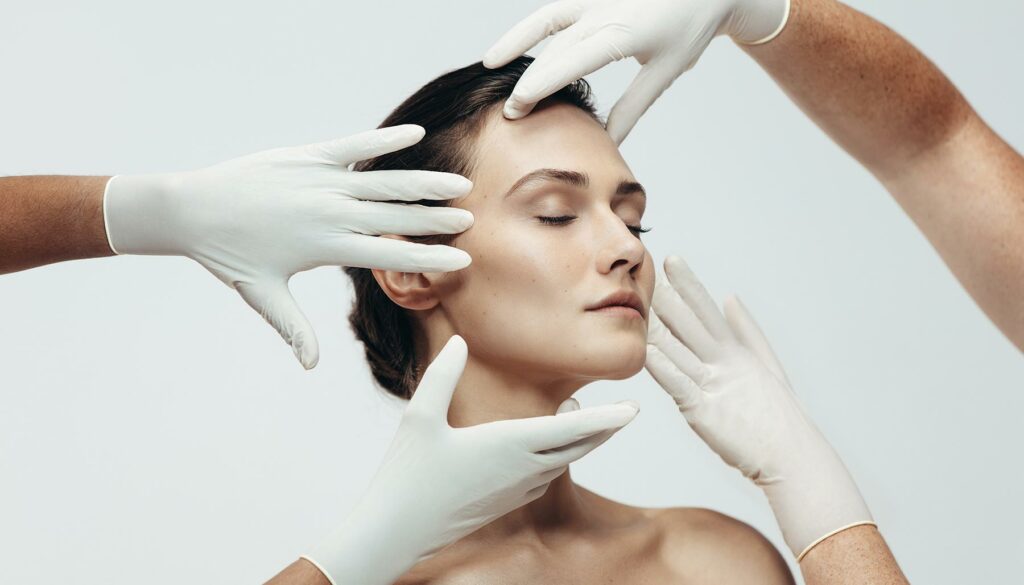 examining a woman's face with gloves, cosomotologists, aestheticians, beauty