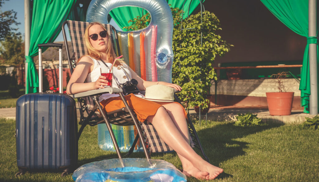 woman sitting in lawn chair drinking from red cup