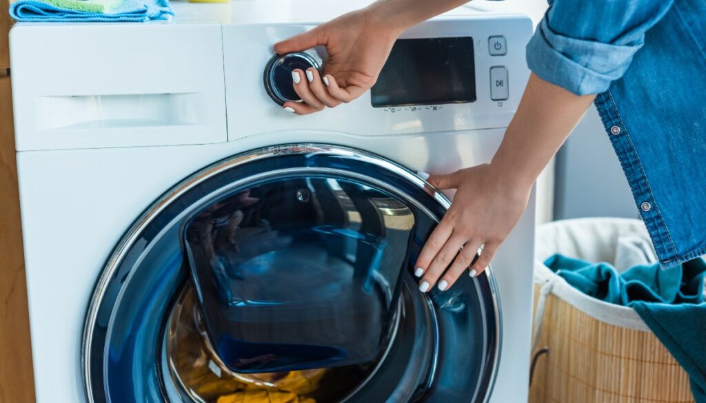 A woman using a washing machine