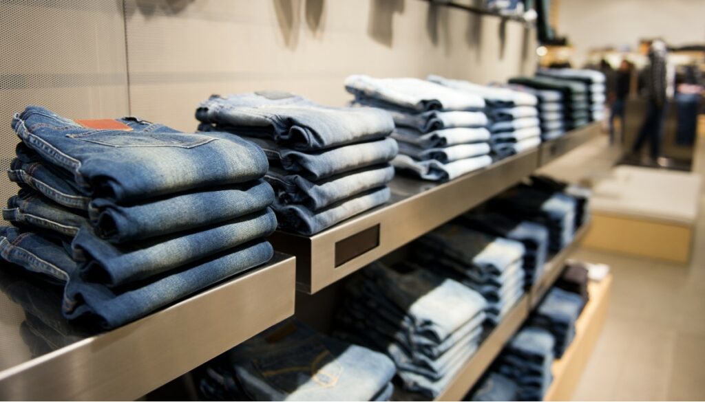 a wall of jeans in a store