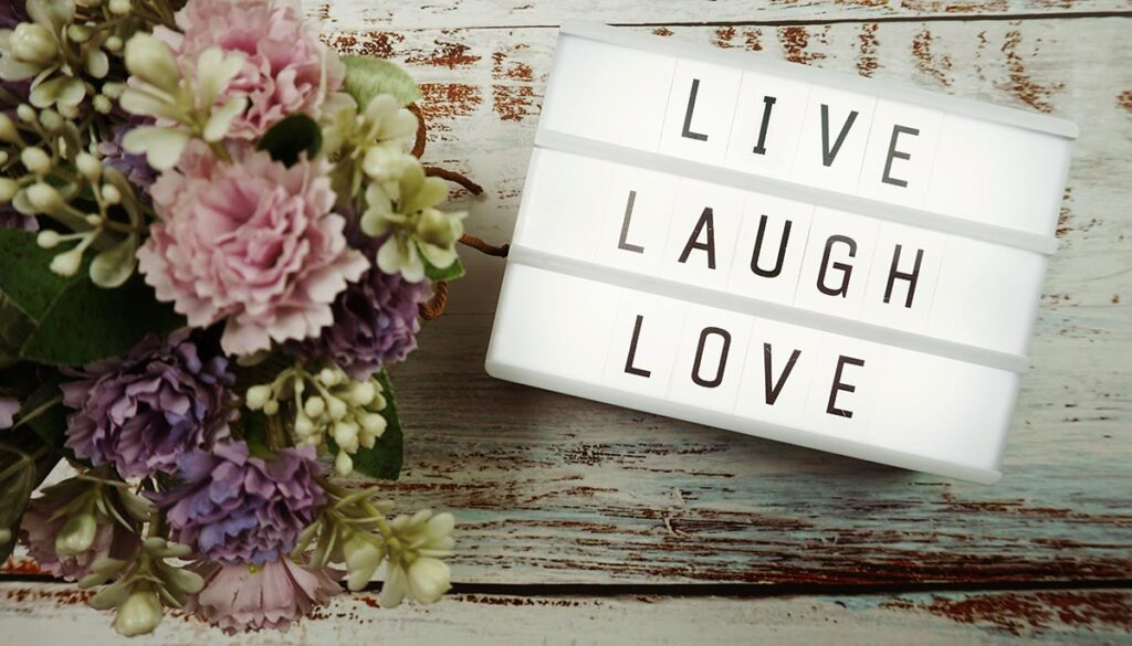Live laugh love sign with flowers on barn wood