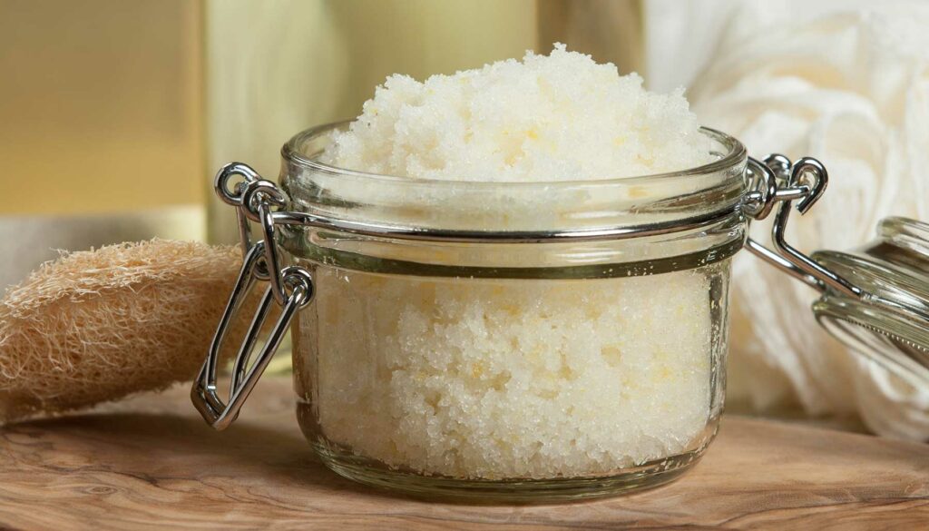 DIY sugar scrub in an open glass jar