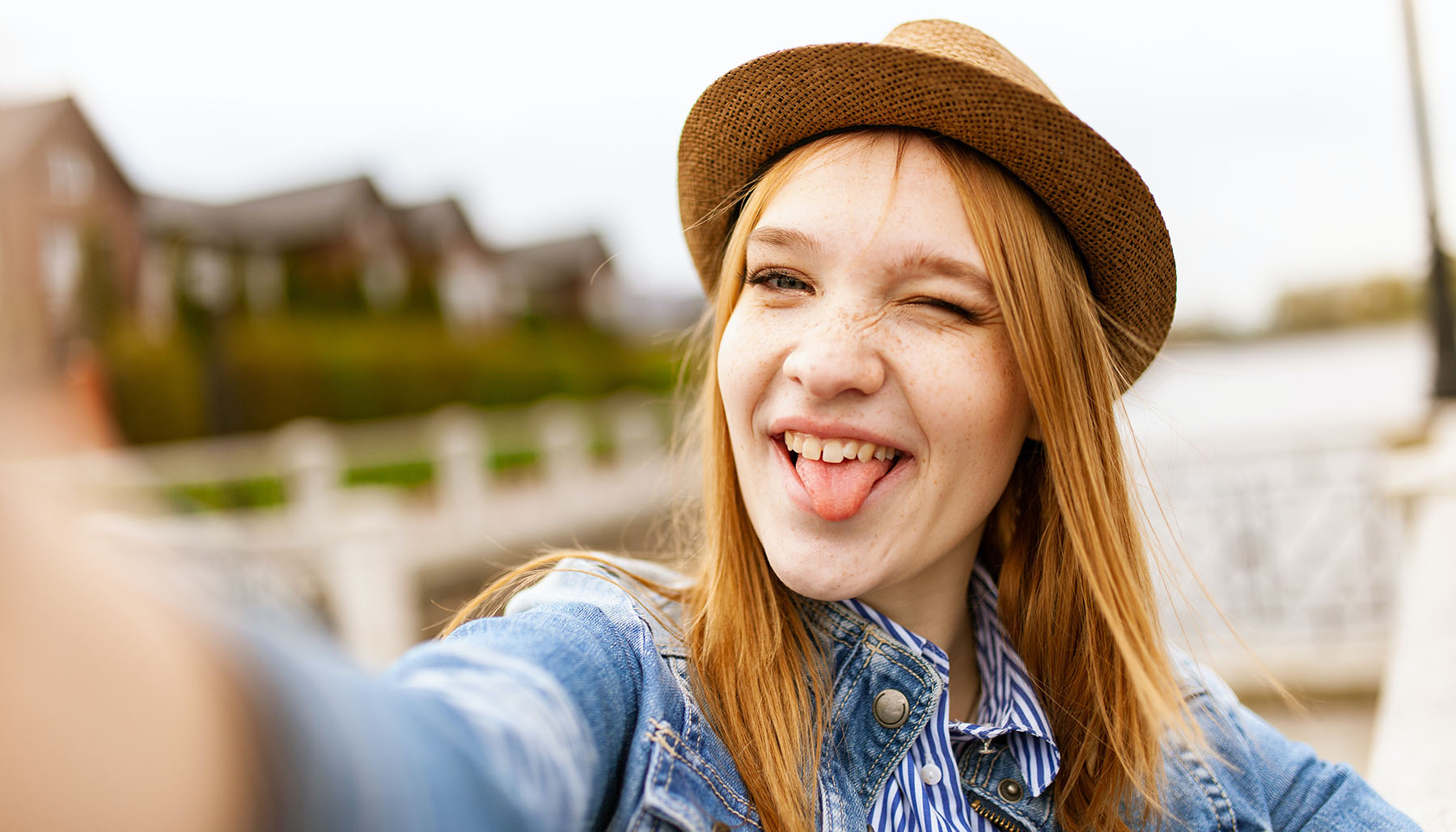Red-headed woman making a goofy face in a selfie
