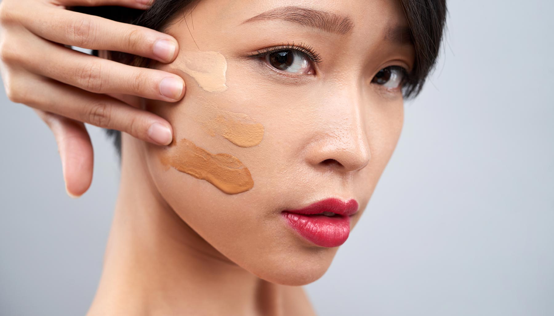 woman with different shades of foundation on her face