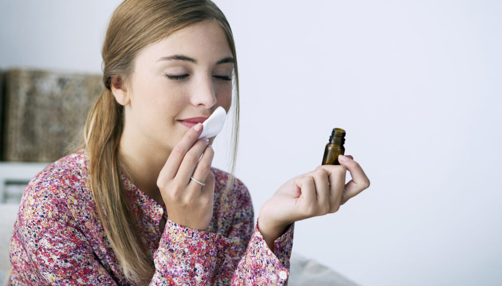 Woman smelling essential oils