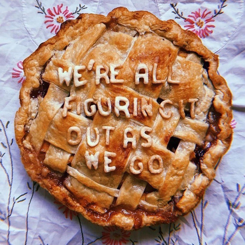 A picture of a pie with the words 'we're all figuring it out as we go' on it