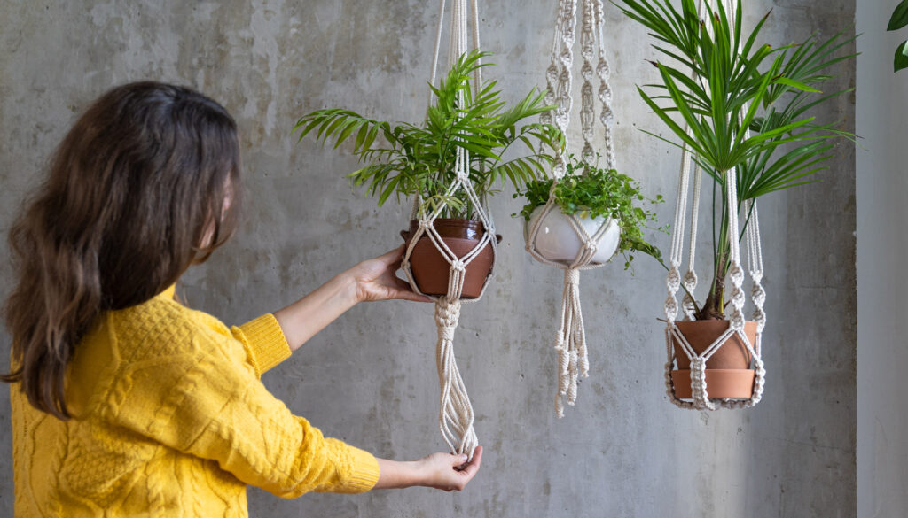 Woman hanging plants