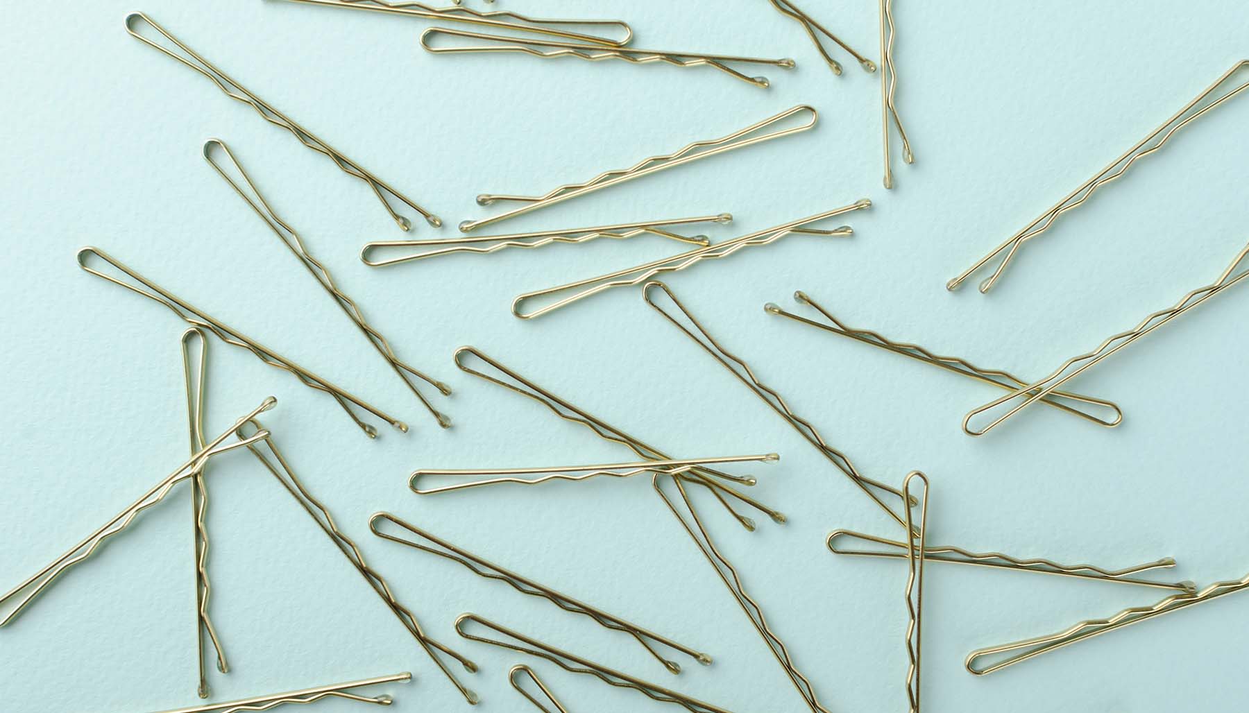 Bobby pins on pale green background