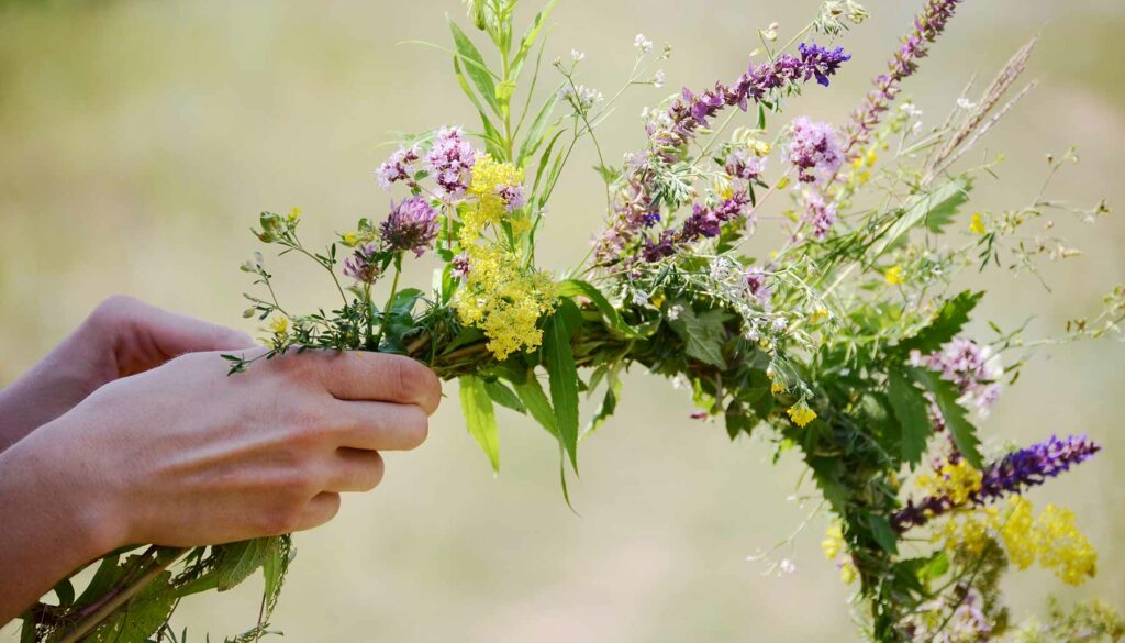 hands crafting a floral spring wreath