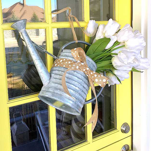 spring wreath made with a metal watering can