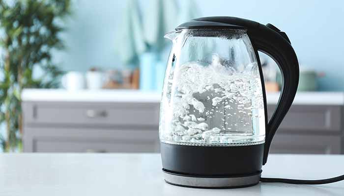 clear glass electric tea kettle boiling water