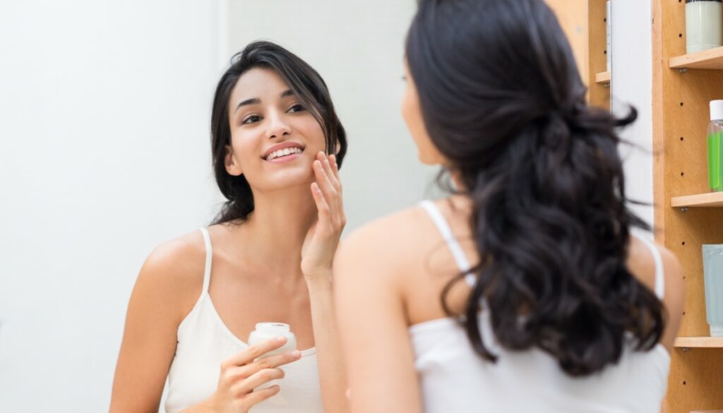 woman putting on skincare