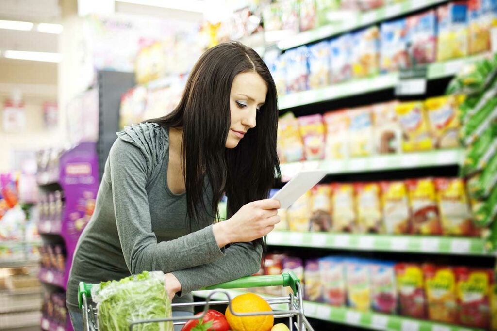 woman with list grocery shopping