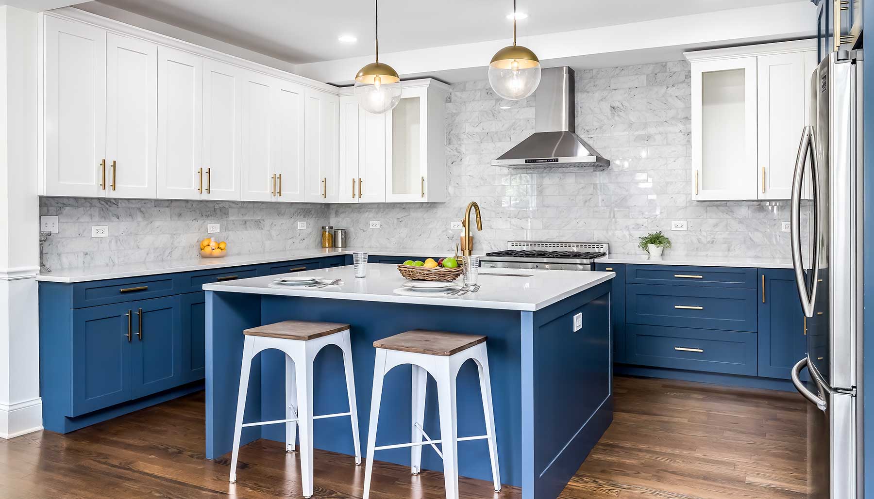 modern kitchen with gold fixtures and painted blue cabinets
