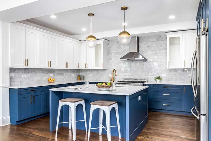 modern kitchen with cabinets painted blue, gold fixtures