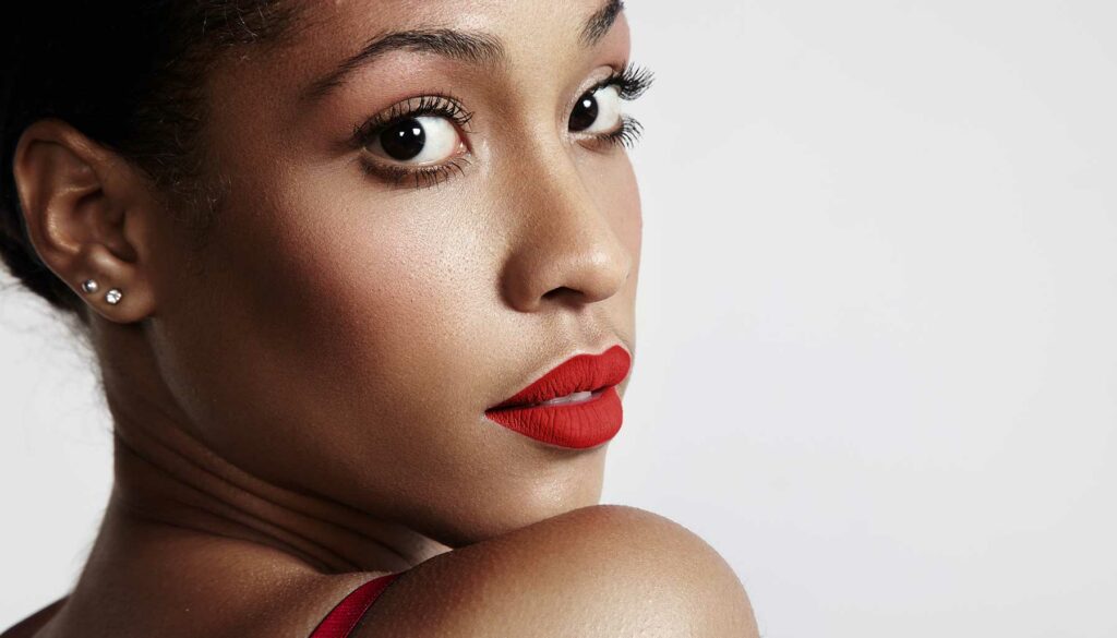 woman looking over her shoulder wearing red lipstick