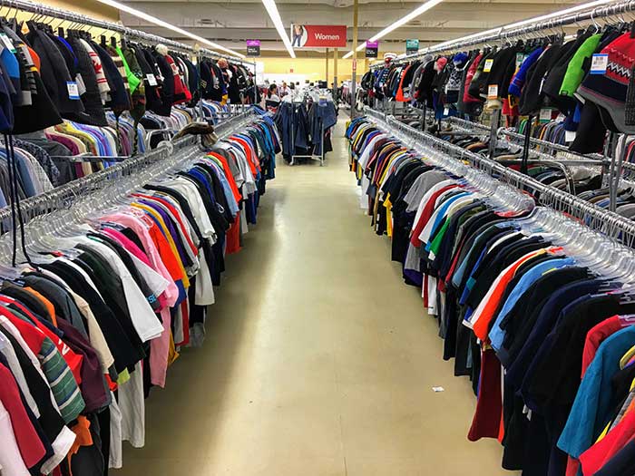 rows of clothing in a thrift store