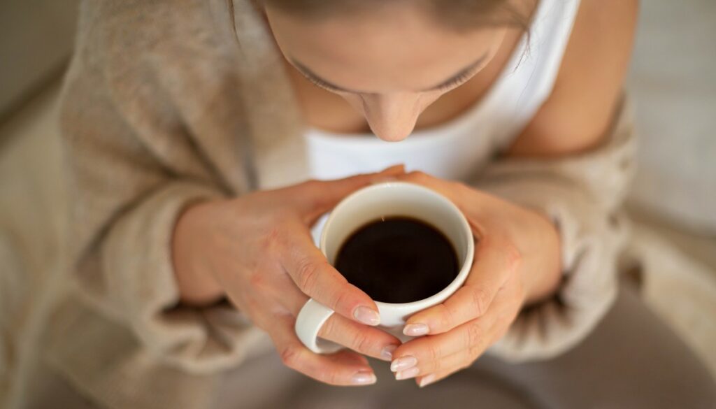 woman drinking black coffee