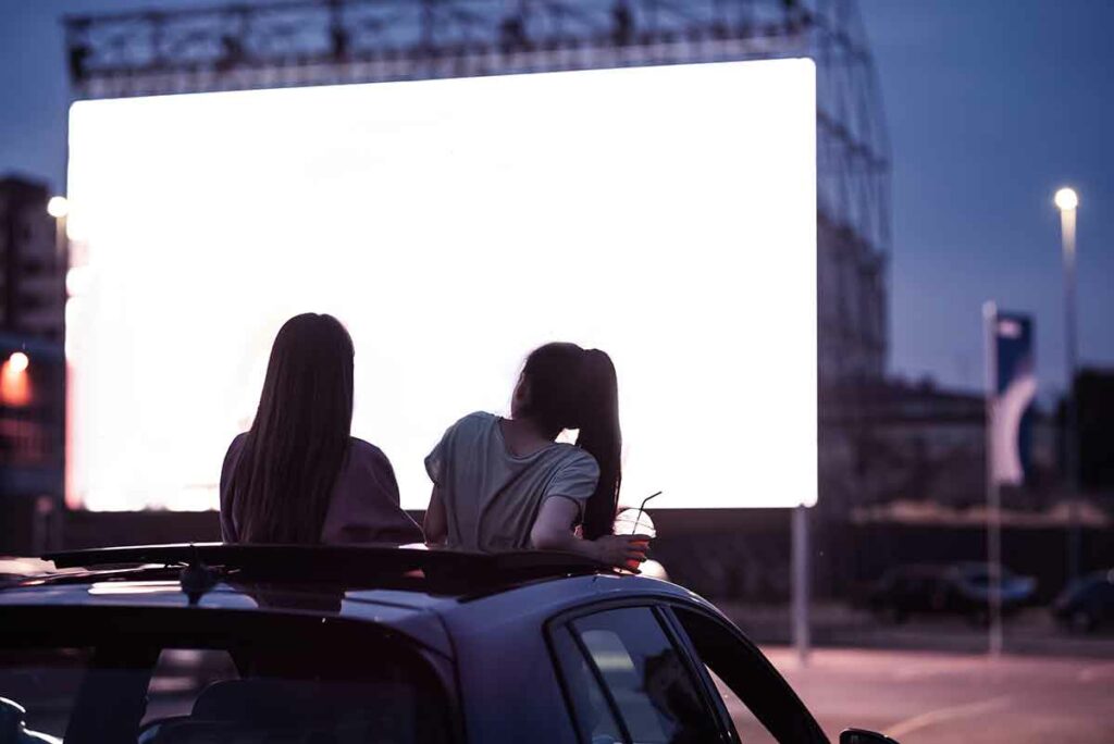 two girls at the drive in movie theater