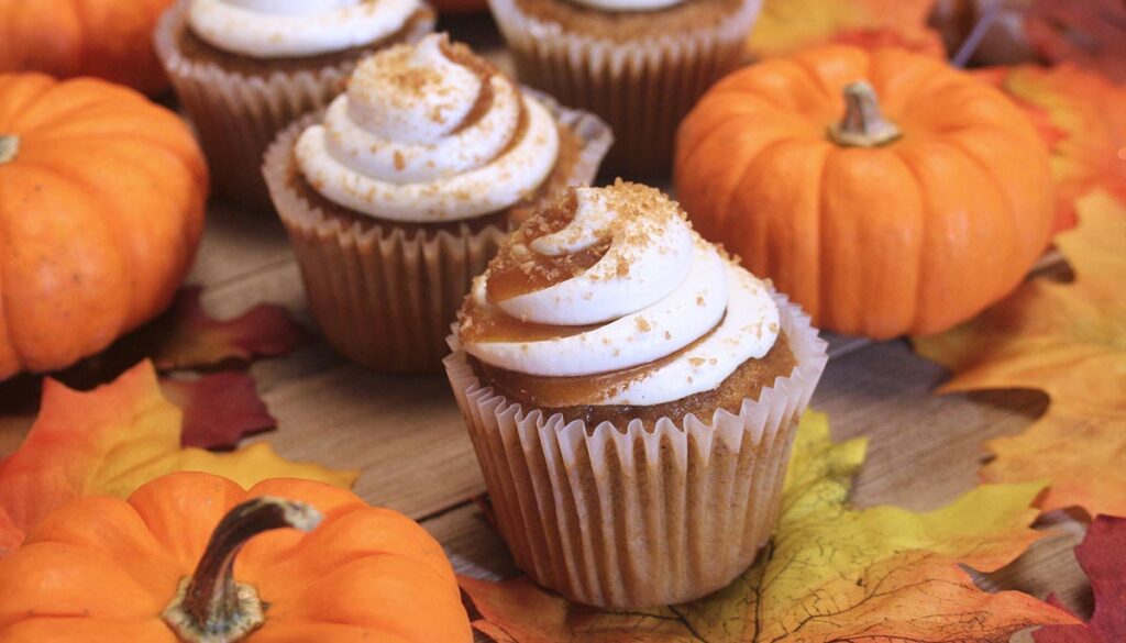 Close up photo of a pumkin spice cupcake with cream cheese frosting