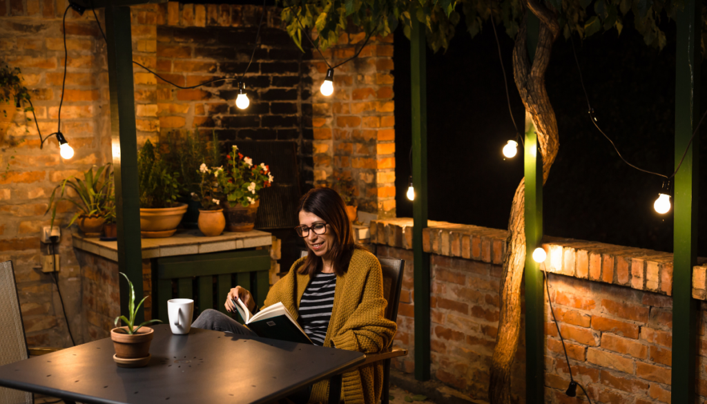 Woman relaxes outside at night