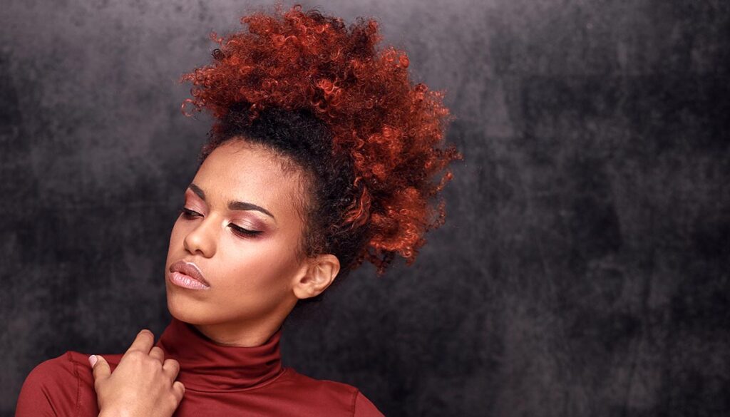 Studio fashion portrait of beautiful african american woman on dark background. Stylish autumn look .