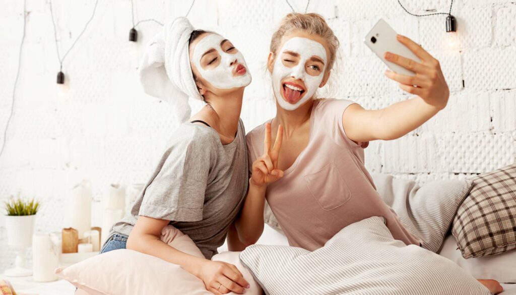 two girls wearing masks taking a selfie