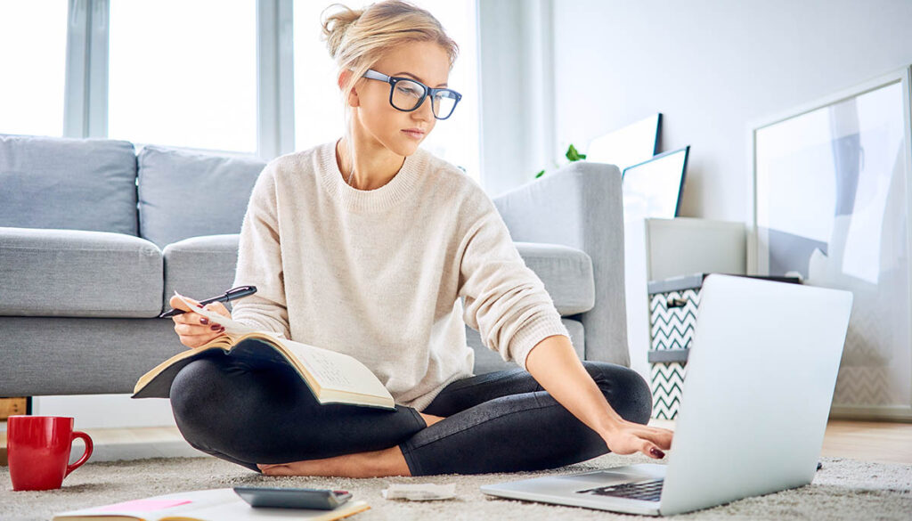Woman using laptop paying bills online and managing home budget