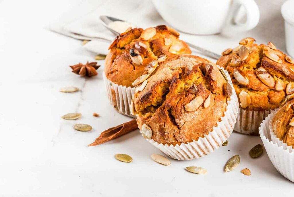 pumpkin muffins with pumpkin seeds on top