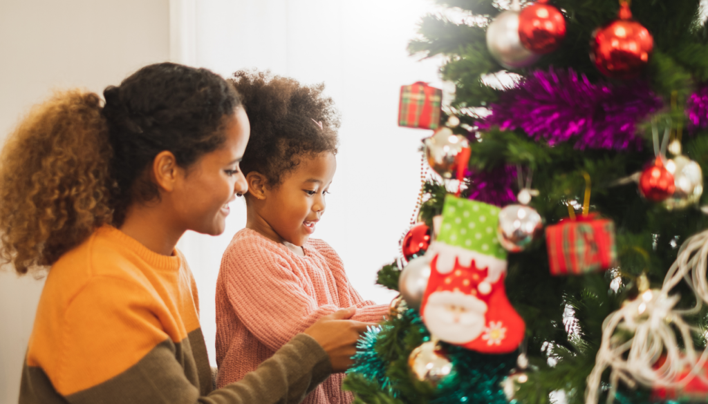 Mom and child decorating Christmas tree