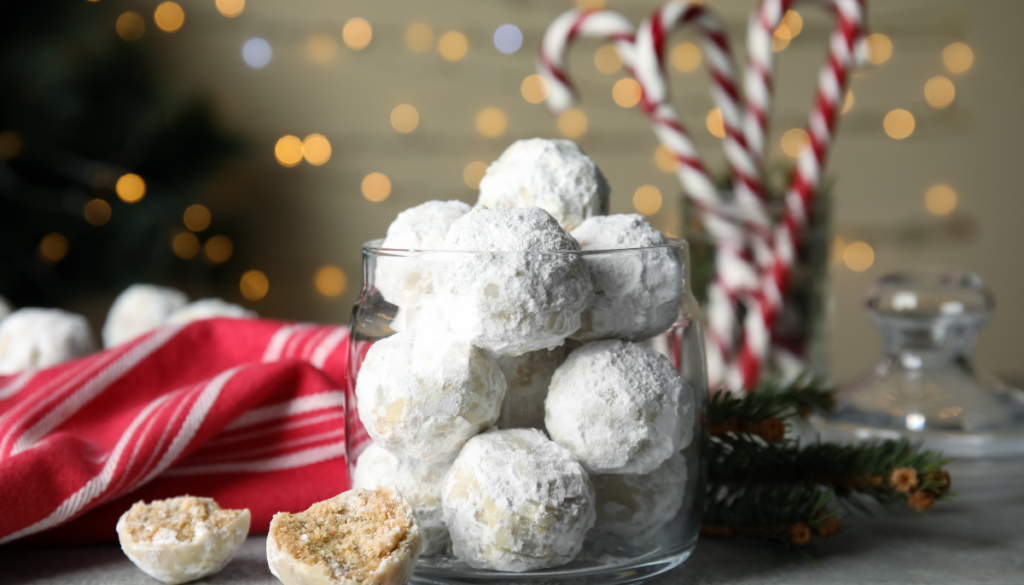 Snowball cookies in glass jar with candy canes in background