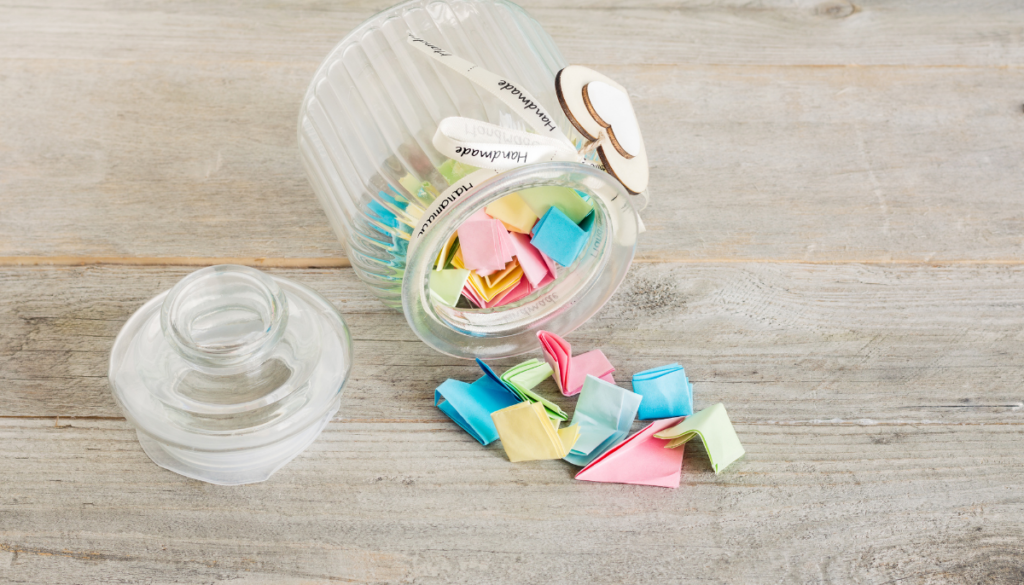 Small jar with folded slips of paper