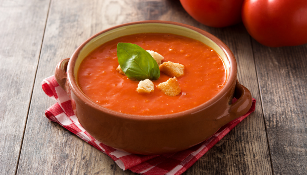 Bowl of tomato soup on napkin
