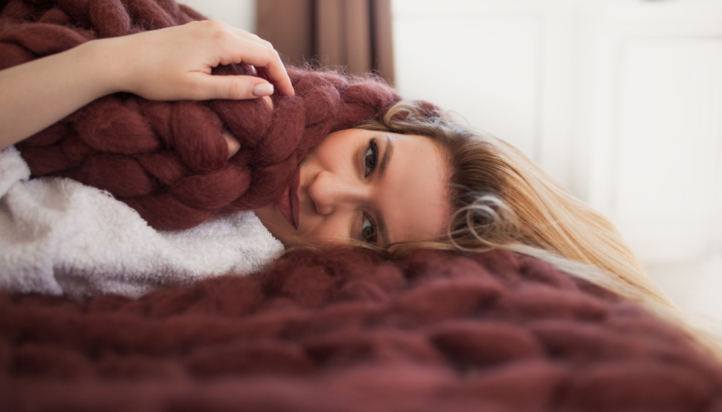 Woman with chunky knit blanket