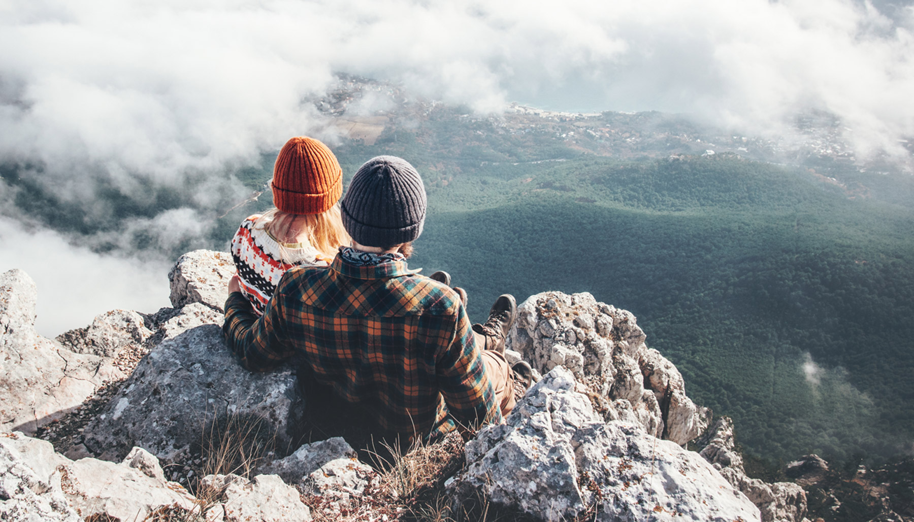 Couple sitting on mountain top