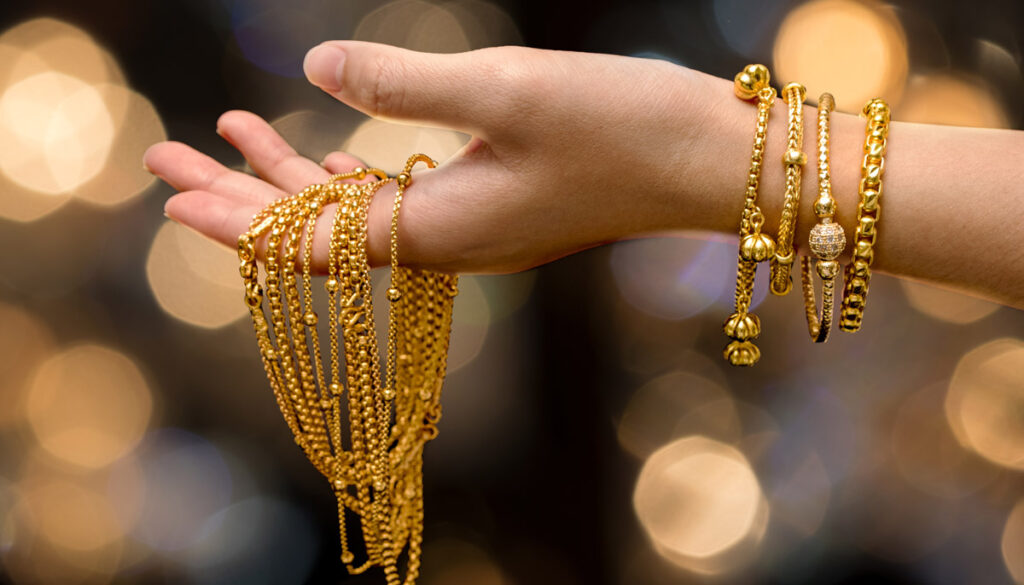 Woman Holding Gold Jewelry