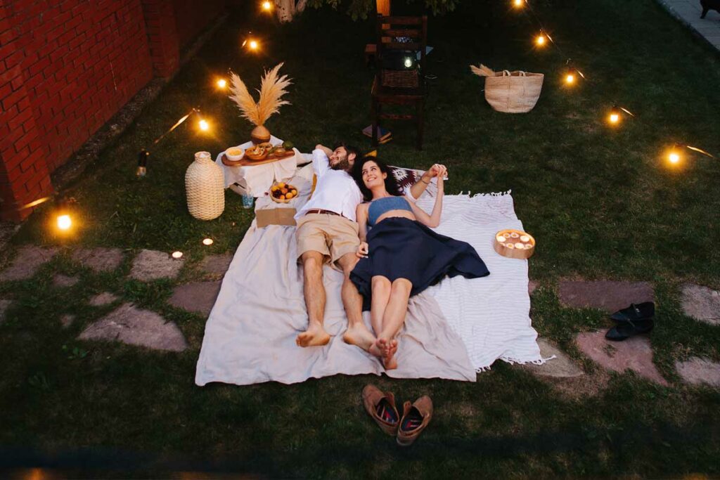 couple on a blanket, having a night time picnic