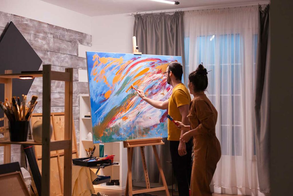 couple painting a canvas together