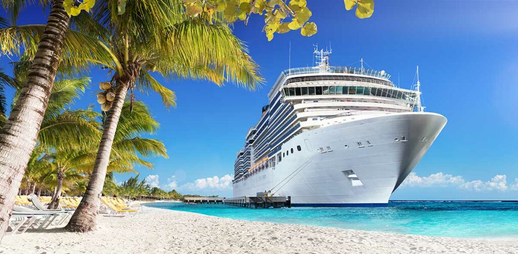 cruise ship docked at an island beach