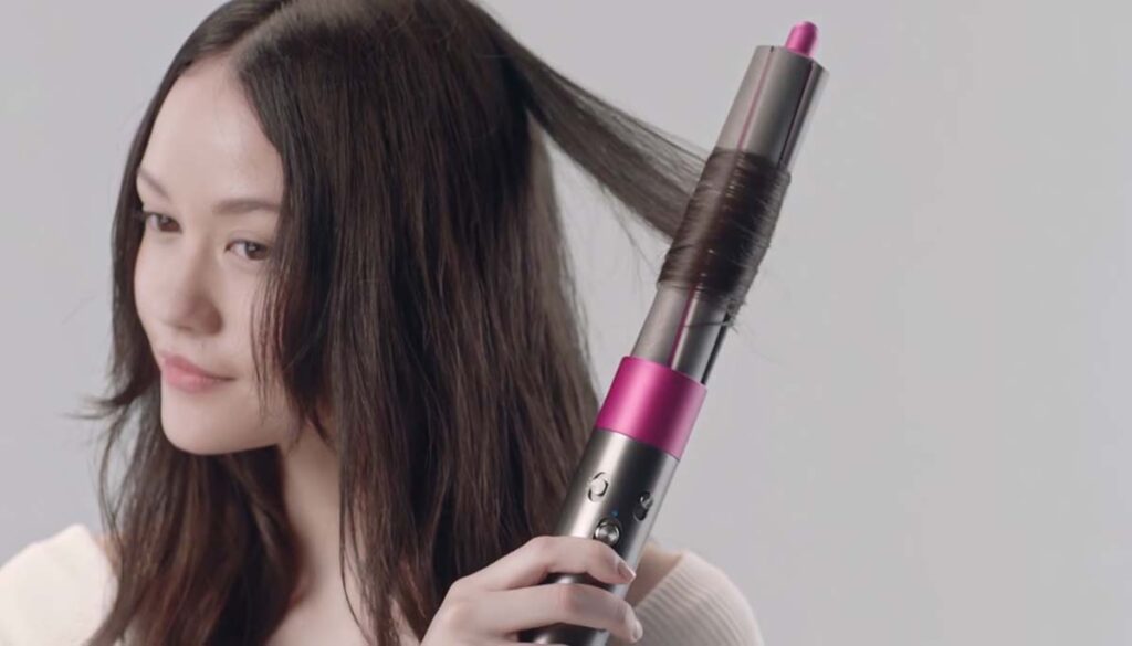 woman using Dyson styler