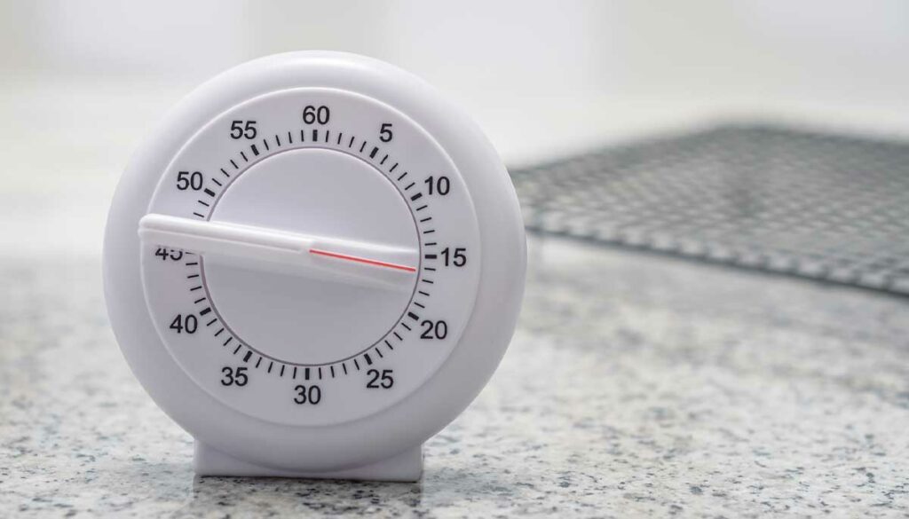 white kitchen timer sitting on a counter