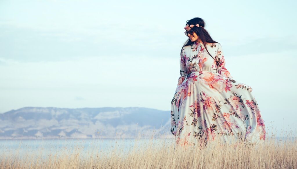 a woman walking in a meadow 