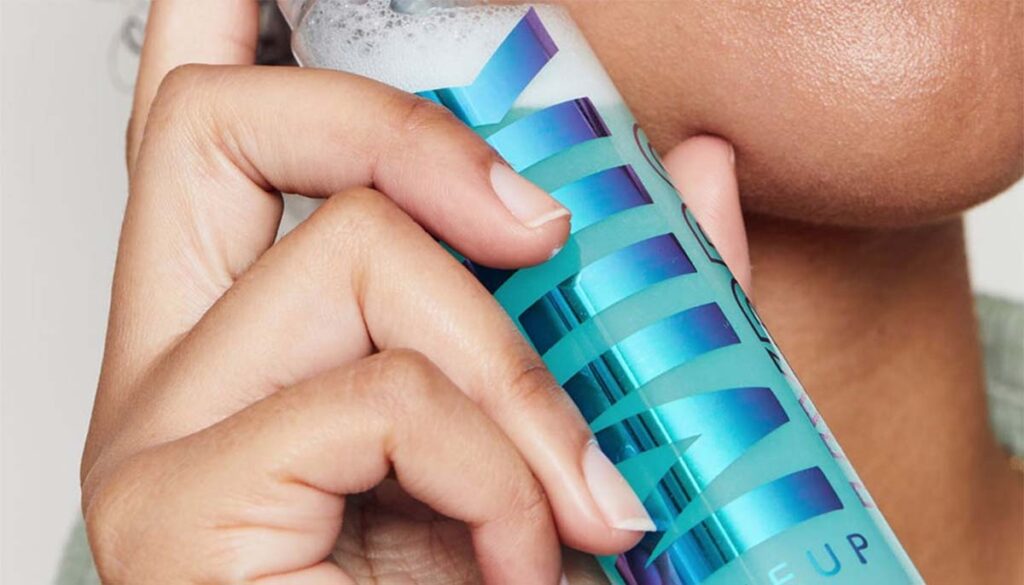 woman holding Milk setting and refreshing spray up to cheek