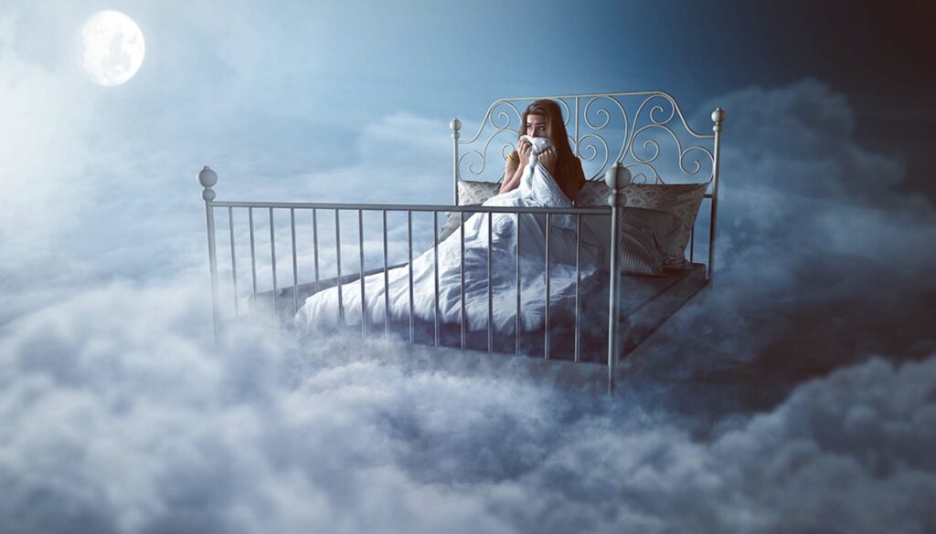 scared woman in her bed in the clouds at night