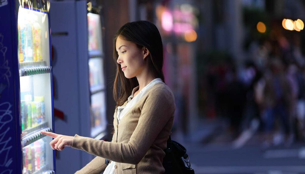 Woman using a vending machine