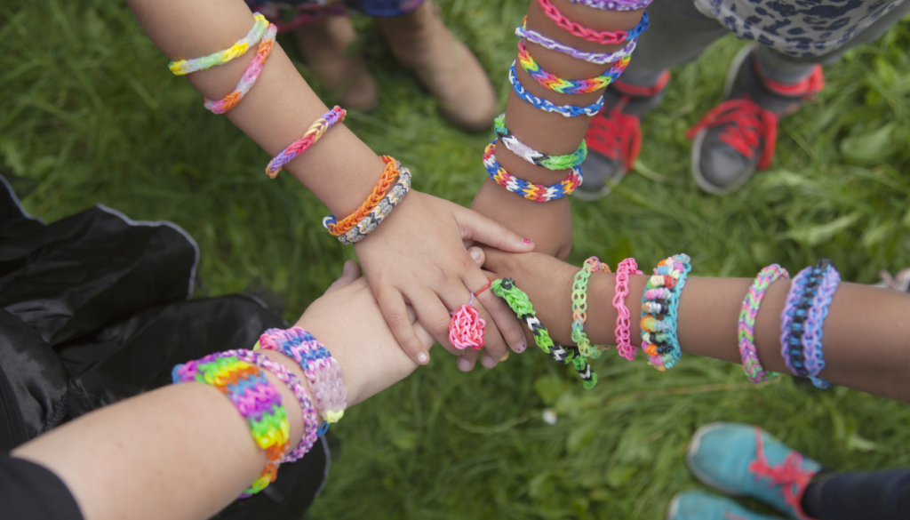 Four arms wearing friendship bracelets