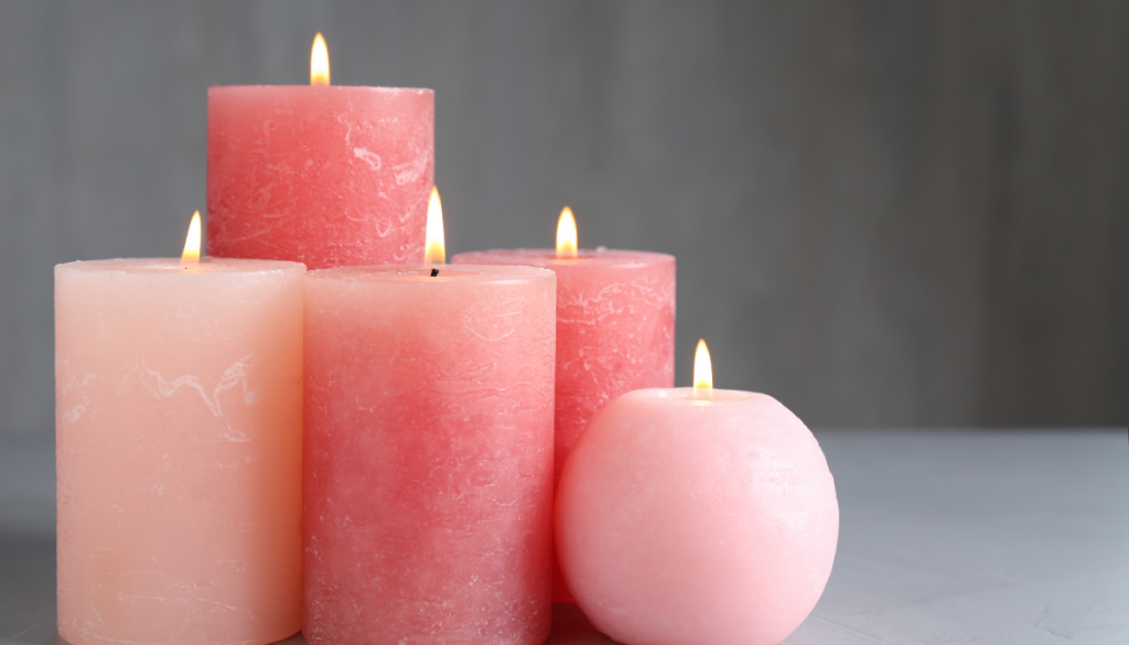 Pink pillar candles and gray background