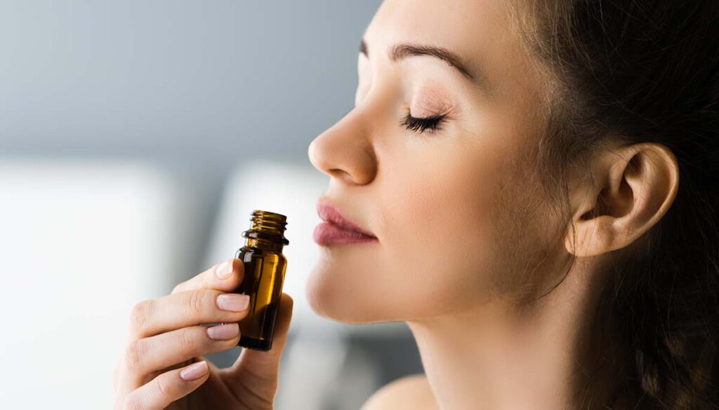 woman inhaling essential oil