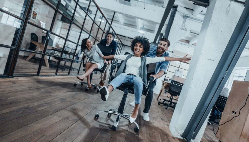 colleagues riding of swivel chairs