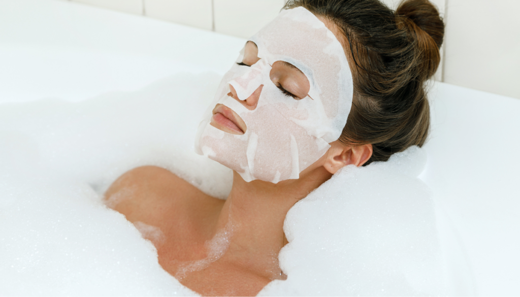 Woman relaxing in tub with a sheet face mask on